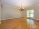 Bright living room featuring hardwood floors, a large window, and classic chandelier at 1448-1 New Prospect Church Rd, Shelby, NC 28150