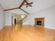 Cozy living room featuring a brick fireplace, hardwood floors, and high ceilings at 1448-1 New Prospect Church Rd, Shelby, NC 28150