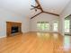Open living room with wood floors, exposed beam, and a cozy fireplace feature at 1448-1 New Prospect Church Rd, Shelby, NC 28150