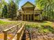 Back of home with a two-story screened porch, outdoor deck, and steps leading to the yard and stream at 1448-1 New Prospect Church Rd, Shelby, NC 28150