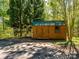 A rustic wooden shed with double doors offers extra storage or workshop space at 1448-1 New Prospect Church Rd, Shelby, NC 28150