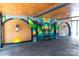 Unique garage featuring vibrant mural art, decorative doors, and a modern bench at 2000 Patio Ct # 129, Charlotte, NC 28205