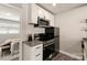 Kitchen features stainless steel appliances, bright white cabinetry, and stylish backsplash at 2000 Patio Ct # 129, Charlotte, NC 28205