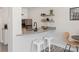 Kitchen area showcasing bar seating, stainless steel appliances, and floating shelves at 2000 Patio Ct # 129, Charlotte, NC 28205