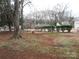 Large backyard with mature trees and a partially fenced area at 2044 Helen Dr, Gastonia, NC 28054