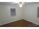 Spacious bedroom with hardwood floors, window with blinds, and ceiling fan at 2044 Helen Dr, Gastonia, NC 28054