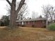 Brick ranch house with a large tree in front at 2044 Helen Dr, Gastonia, NC 28054