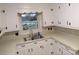 Bright kitchen featuring ample white cabinetry, stainless steel sink, and a window offering a view of the outdoors at 2044 Helen Dr, Gastonia, NC 28054