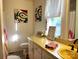 Clean bathroom with yellow vanity, shower, and decorative touches at 217 Brent St, Wadesboro, NC 28170