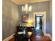 Bright dining room features chandelier, hardwood floors, and view to entryway at 217 Brent St, Wadesboro, NC 28170