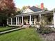 Charming yellow house with wrap-around porch and landscaped yard at 217 Brent St, Wadesboro, NC 28170