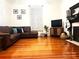 Spacious living room with hardwood floors, brown sectional sofa and fireplace at 217 Brent St, Wadesboro, NC 28170