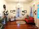 Living room with hardwood floors, fireplace, and two orange couches at 217 Brent St, Wadesboro, NC 28170