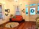 Living room with hardwood floors, orange couch, and decorative accents at 217 Brent St, Wadesboro, NC 28170