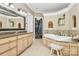 Bathroom features a soaking tub, granite vanity, and walk-in shower at 227 Wildwood Cove Dr, Mooresville, NC 28117