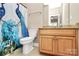 Clean bathroom with granite countertop and wood cabinets at 227 Wildwood Cove Dr, Mooresville, NC 28117