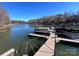 Private boat docks on a tranquil lake with multiple slips for various watercraft at 227 Wildwood Cove Dr, Mooresville, NC 28117