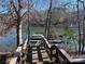 Steps leading down to private boat docks and a serene lakefront view at 227 Wildwood Cove Dr, Mooresville, NC 28117