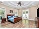 Spacious main bedroom with hardwood floors and access to patio at 227 Wildwood Cove Dr, Mooresville, NC 28117