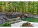 Relaxing spa and refreshing pool with waterfall feature at 227 Wildwood Cove Dr, Mooresville, NC 28117