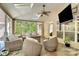 Spacious screened porch with wicker furniture and a TV at 227 Wildwood Cove Dr, Mooresville, NC 28117