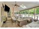 Relaxing screened porch with wicker furniture overlooking the pool at 227 Wildwood Cove Dr, Mooresville, NC 28117
