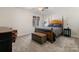 Cozy bedroom with wood post bed, carpet flooring, and ample natural light at 3406 Red Fox Trl, Weddington, NC 28104