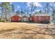 Ranch style home with red siding, mature trees, and a large backyard at 3406 Red Fox Trl, Weddington, NC 28104