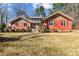 Ranch style home with red siding, mature landscaping, and a spacious yard at 3406 Red Fox Trl, Weddington, NC 28104