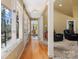 Bright hallway with hardwood floors, leading to the living areas at 3406 Red Fox Trl, Weddington, NC 28104