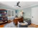 Bright home office featuring built-in shelving and comfortable seating at 3406 Red Fox Trl, Weddington, NC 28104