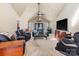 Spacious living room with vaulted ceilings, comfortable seating, and a large TV at 3406 Red Fox Trl, Weddington, NC 28104