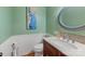 Charming powder room with wood vanity and decorative mirror at 3406 Red Fox Trl, Weddington, NC 28104