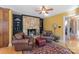 Cozy sitting area with stone fireplace and comfortable leather chairs at 3406 Red Fox Trl, Weddington, NC 28104