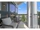 Relaxing balcony with two wicker chairs and window views at 3630 N Davidson St # 4413, Charlotte, NC 28205