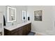 Modern bathroom with double vanity and illuminated mirrors at 3630 N Davidson St # 4413, Charlotte, NC 28205