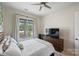 Spacious bedroom with a flat screen TV and large window at 3630 N Davidson St # 4413, Charlotte, NC 28205