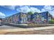 Modern commercial building with vibrant mural and outdoor seating at 3630 N Davidson St # 4413, Charlotte, NC 28205