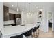 Open concept kitchen featuring dark cabinetry and a breakfast bar at 3630 N Davidson St # 4413, Charlotte, NC 28205