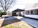 Outdoor living space with covered patio, dining set, grill, and modern shed for storage and entertaining at 4837 Holbrook Dr, Charlotte, NC 28212