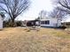 Expansive backyard featuring a fire pit, covered patio, and outdoor seating for ultimate relaxation at 4837 Holbrook Dr, Charlotte, NC 28212