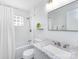 Clean, bright bathroom featuring a shower and tub with decorative white tile at 4837 Holbrook Dr, Charlotte, NC 28212