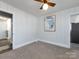 Bright bedroom with paneled walls, neutral carpet, and access to other rooms in the home at 4837 Holbrook Dr, Charlotte, NC 28212