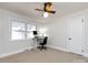 This bedroom has neutral walls and carpet, a ceiling fan, and an in-room office at 4837 Holbrook Dr, Charlotte, NC 28212