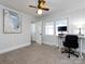Bedroom with white walls, neutral carpet, ceiling fan, and an in-room office setup at 4837 Holbrook Dr, Charlotte, NC 28212