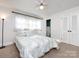 This bedroom features neutral walls, carpet, ceiling fan, and access to an attached half bath at 4837 Holbrook Dr, Charlotte, NC 28212