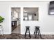 Bright dining area view into kitchen, featuring white cabinets and stainless appliances at 4837 Holbrook Dr, Charlotte, NC 28212