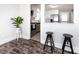 Bright dining area view into kitchen, featuring white cabinets and stainless appliances at 4837 Holbrook Dr, Charlotte, NC 28212