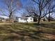 Spacious yard surrounds a charming home, creating a serene outdoor living space at 4837 Holbrook Dr, Charlotte, NC 28212