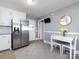 Bright kitchen features stainless steel refrigerator and eat-in dining area at 4837 Holbrook Dr, Charlotte, NC 28212